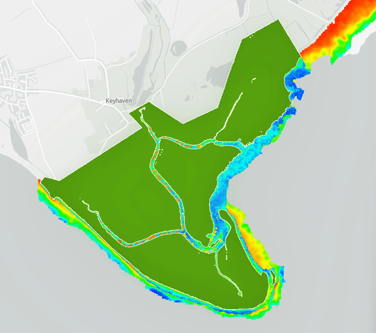 Coastal monitoring map near Keyhaven, UK showing salt marsh extent in green with shoreline change detection along tidal channels and coastal margins displayed in a blue-to-red depth and change gradient
