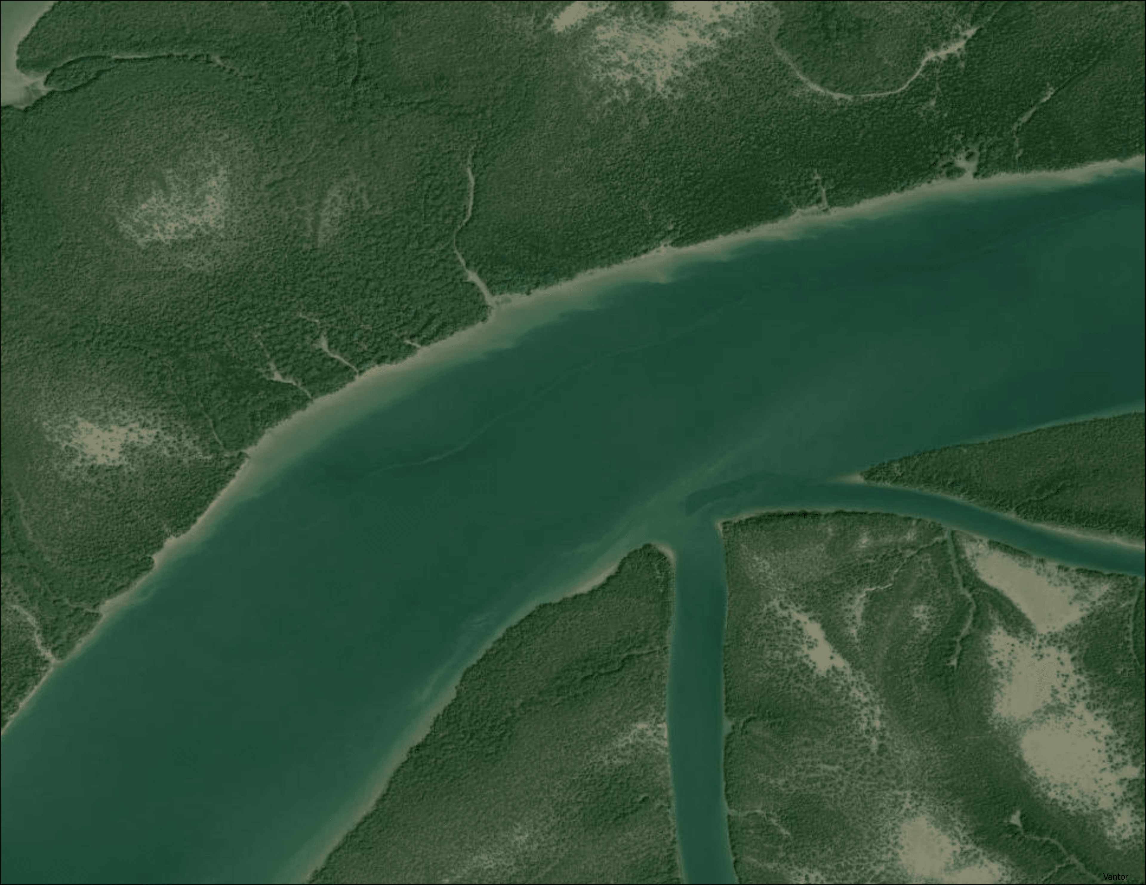 True-color satellite imagery of a Karachi tidal estuary showing dense dark green mangrove forest flanking a wide tidal channel with branching creek networks