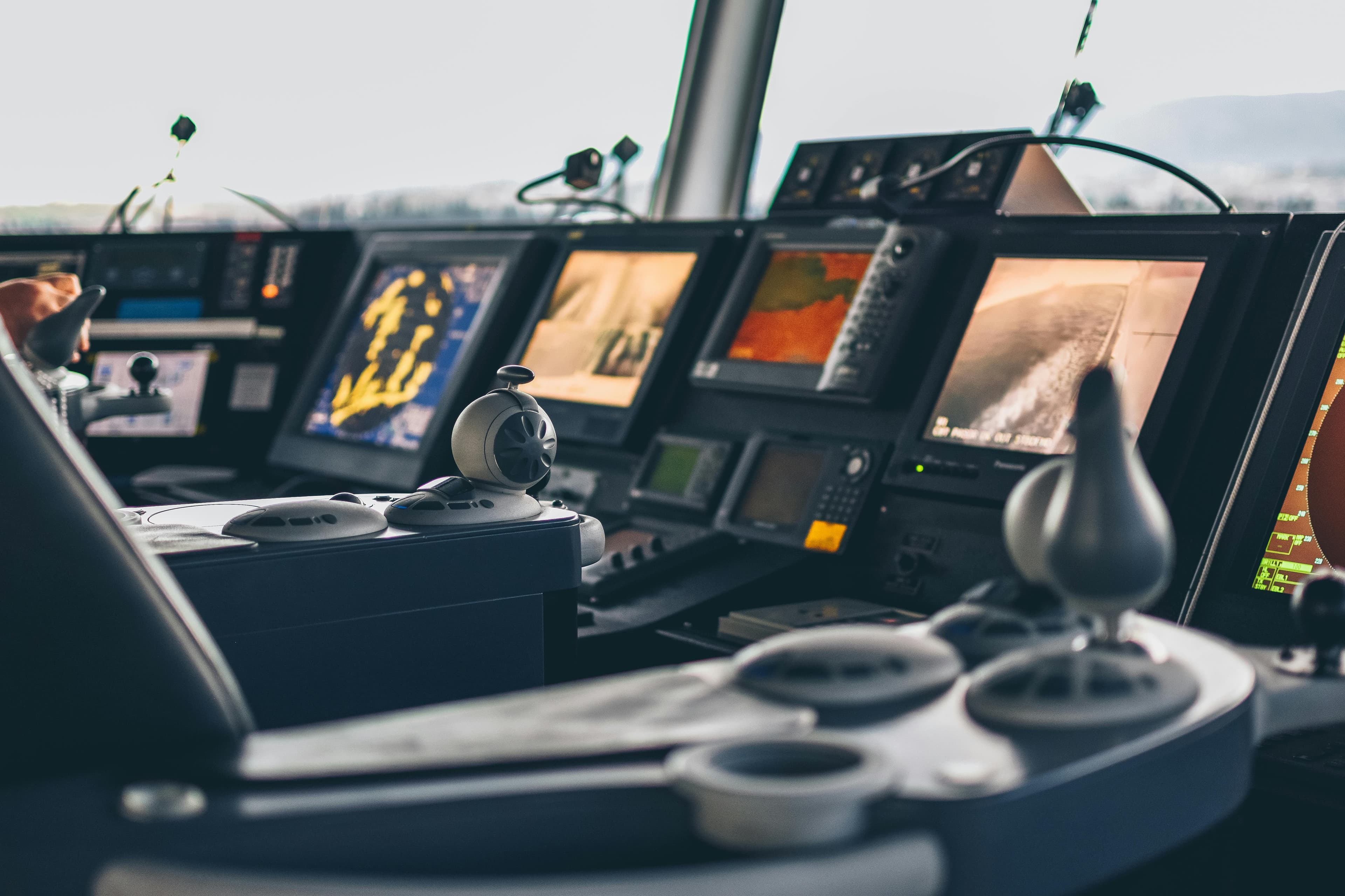 Commercial vessel bridge with multiple marine electronics displays for nautical charting and navigation